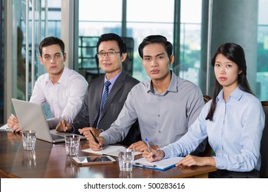 Serious Business People Having Meeting In Office