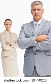 Serious Business People Standing With Folded Arms Against White Background