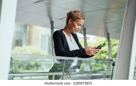 Serious Business Woman Using Mobile Phone At Office Balcony