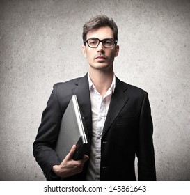 Serious Businessman With Glasses And Laptop 