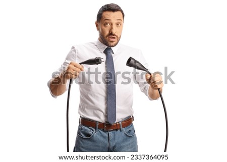 Serious businessman unplugging cables isolated on white background