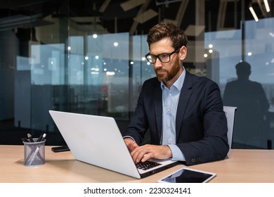 Serious businessman working inside office at work, mature boss in business suit sitting at computer and table, senior man thinking. - Powered by Shutterstock