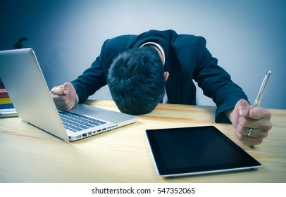 Serious businessman working with tablet at office. - Powered by Shutterstock