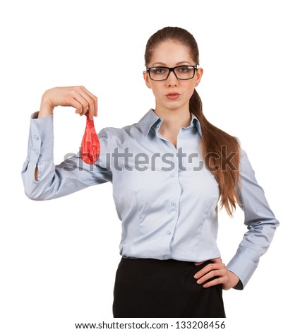 Serious businesswoman in glasses holding a deflated balloon