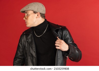 Serious, calm and composed. Young male portrait isolated on red studio background with copyspace for ad. Beautiful model. Concept of human emotions, facial expression, youth culture. Profile view