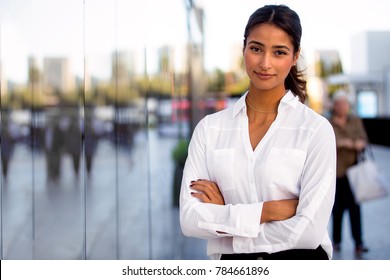 Serious career motivated successful female business professional standing proud and confident near downtown financial buildings