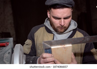 A serious carpenter measures the correct geometry of the Board with a square - Powered by Shutterstock