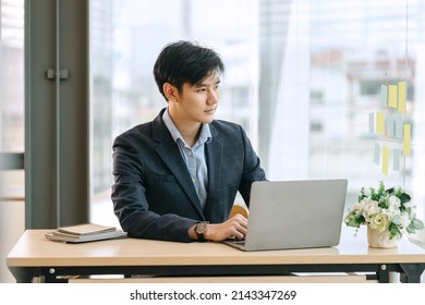 Serious Casual Asian Business Man Online Working On Laptop Computer Screen.