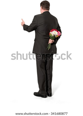 Similar – Man in jeans and plaid shirt with some white flowers in his hand