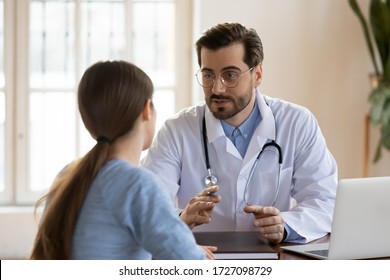 Serious Caucasian male doctor in white medical uniform talk discuss results or symptoms with female patient, man GP or physician consult woman client give recommendation at meeting in hospital - Shutterstock ID 1727098729