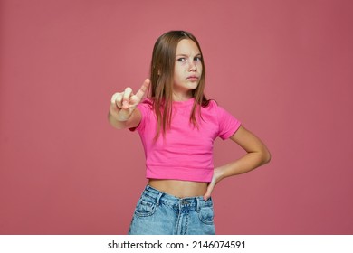Serious child girl warning, says be careful, showing stop gesture, saying no by raised up finger, disapprove something - Shutterstock ID 2146074591