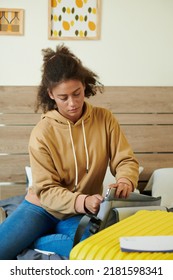 Serious College Girl Packing Laptop In Bag When Leaving For University