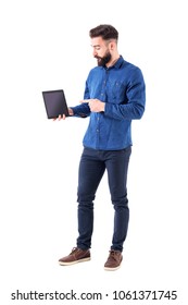 Serious Confident Business Man Pointing Finger At Tablet And Presenting Pad Application. Full Body Isolated On White Background.