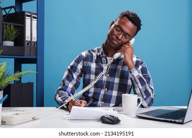 Serious Confident Company Insurer On Landline Call With Potential Customer Talking About Life Policy. Reliable Trustful Office Worker Writing Down Informations While Having Telephone Conversation.