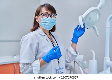 Serious Confident Female Doctor Dentist In A Face Mask In A Dental Office