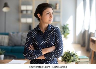 Serious Confident Young Indian Girl Student Professional Look Away Forward To Future Dream Of Success At Home Office, Thoughtful Lady Arm Cross Stand Indoor Think Of Entrepreneurship Ambition Concept