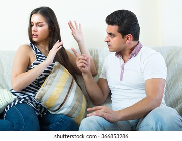 Serious conversation between angry husband and his attractive young wife at home  - Shutterstock ID 366853286