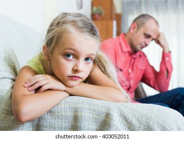 Serious Dad And Offended American Little Girl Quarrelling Indoors. Focus On Girl