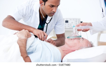 Serious doctor resuscitating a patient in a hospital - Powered by Shutterstock