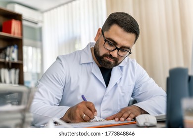 Serious doctor sitting at computer. Medical office. Doctor at work. Diagnosing. - Shutterstock ID 1773848846