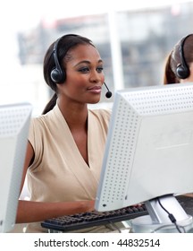 Serious ethnic businesswoman with headset on working in a call center - Shutterstock ID 44832514