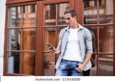 Serious Executive Manager 40 Years Old Looking News On Smartphone Reading Email About Business Using Mobile Phone With 4G Internet Near Building In New York. Confident Serious Man Having Work Online