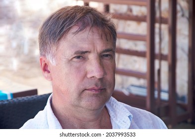 Serious Face Of A European Man Middle-aged Man, Over 50, Close-up. Street Portrait Of A Sad Male Of Fifty Years Old, In A European City, Closeup.