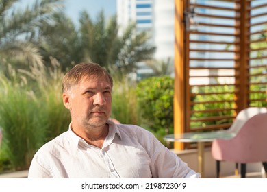 Serious Face Of A European Man Middle-aged Man, Over 50, Close-up. Street Portrait Of A Sad Male Of Fifty Years Old