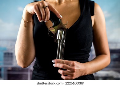 Serious Faceless Woman In A Stylish Dress Holds A Revolver For A Shot Against The Background Of Office Windows. Woman Killer Shooting. Office Robbery