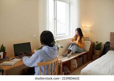 Serious Female College Students Studying In Dormitory