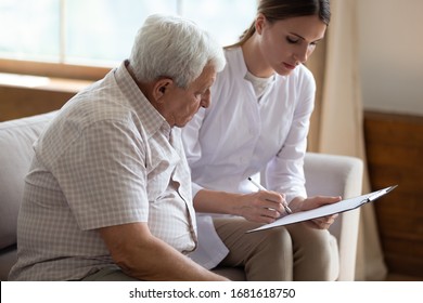 Serious Female Doctor Filling Older Patient Checkup Form During Visit, Writing In Documents, Medical History Or Anamnesis, Disease Prevention, Medical Insurance Contract, Elderly Man Checkup