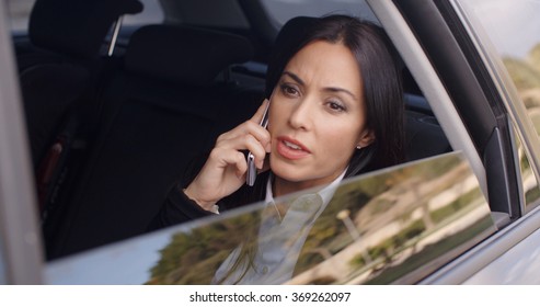 Serious Female Executive On Phone In Limousine