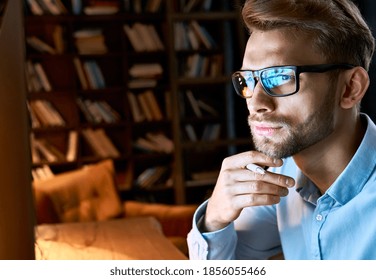 Serious Focused Businessman Wearing Computer Glasses Looking At Pc Screen With Computer Reflection Using Internet, Watching Webinar Training, Working Online By Video Conference, Close Up Face View.