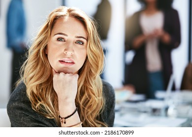 Serious, Focused And Confident Businesswoman Sitting In A Modern Business Office Workplace. Portrait Of An Attractive, Edgy And Blonde Female Corporate Professional Working At A Startup Company