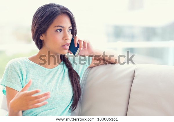 Serious Girl Sitting On Sofa Making People Business