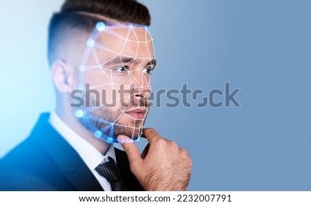 Serious handsome businessman touching chin with facial recognition by digital interface with line connection hologram. Concept of modern technology of artificial intelligence biometric scanning