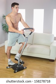 Serious Handsome Man Training On Stair Climber In Bright Living Room