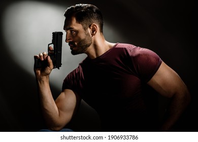 Serious Hollywood Styled Film Actor Holding Gun Like Secret Agent