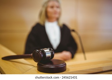 Serious Judge With A Gavel Wearing Robes In The Court Room