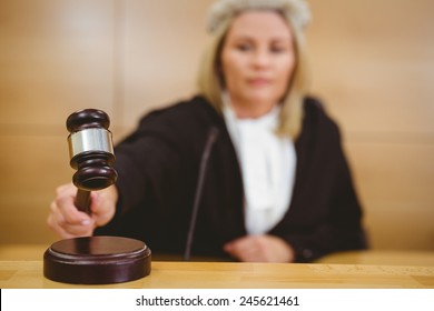 Serious Judge With A Gavel Wearing Robes And Wig In The Court Room