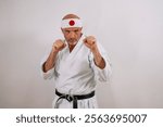 Serious karate master with white kimono and black belt.