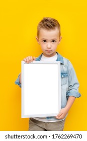 Serious Kid Holding White Frame With Copy Space For Text Certificate Or Diploma