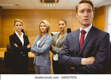 Serious Lawyer Standing With Arms Crossed In The Court Room