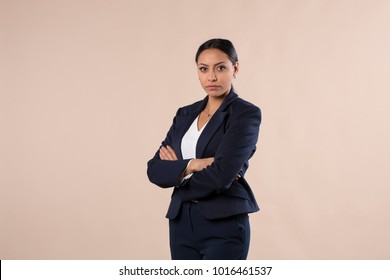 Serious Looking Hispanic Business Woman With Her Arms Crossed 
