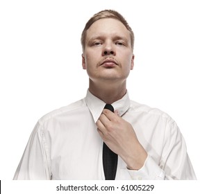 Serious looking man fixing his tie. Portrait isolated on white background.