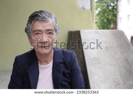 Serious looking senior woman with short gray hairstyle 