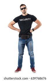 Serious Macho Bouncer Or Undercover Officer With Hands On Hips Looking At Camera. Full Body Length Portrait Isolated On White Studio Background. 