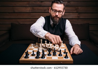 Serious Male Chess Player Makes Victory Move