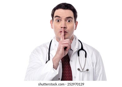 Serious male doctor instruct to keep silence