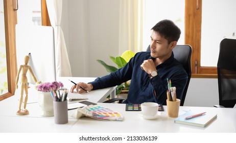 Serious male graphic designer focusing and pensive thinking creative idea on his project in office. - Powered by Shutterstock